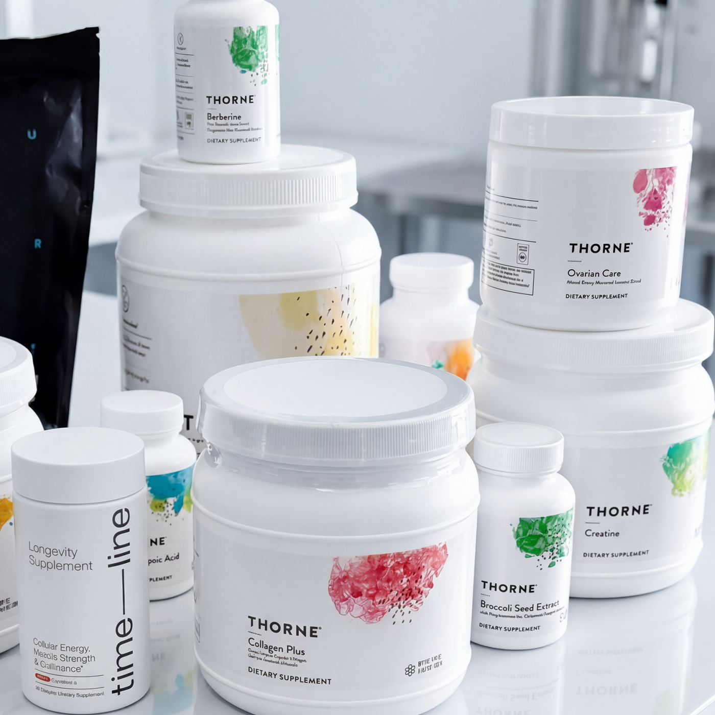 Collection of Thorne Research supplement containers on a white surface.